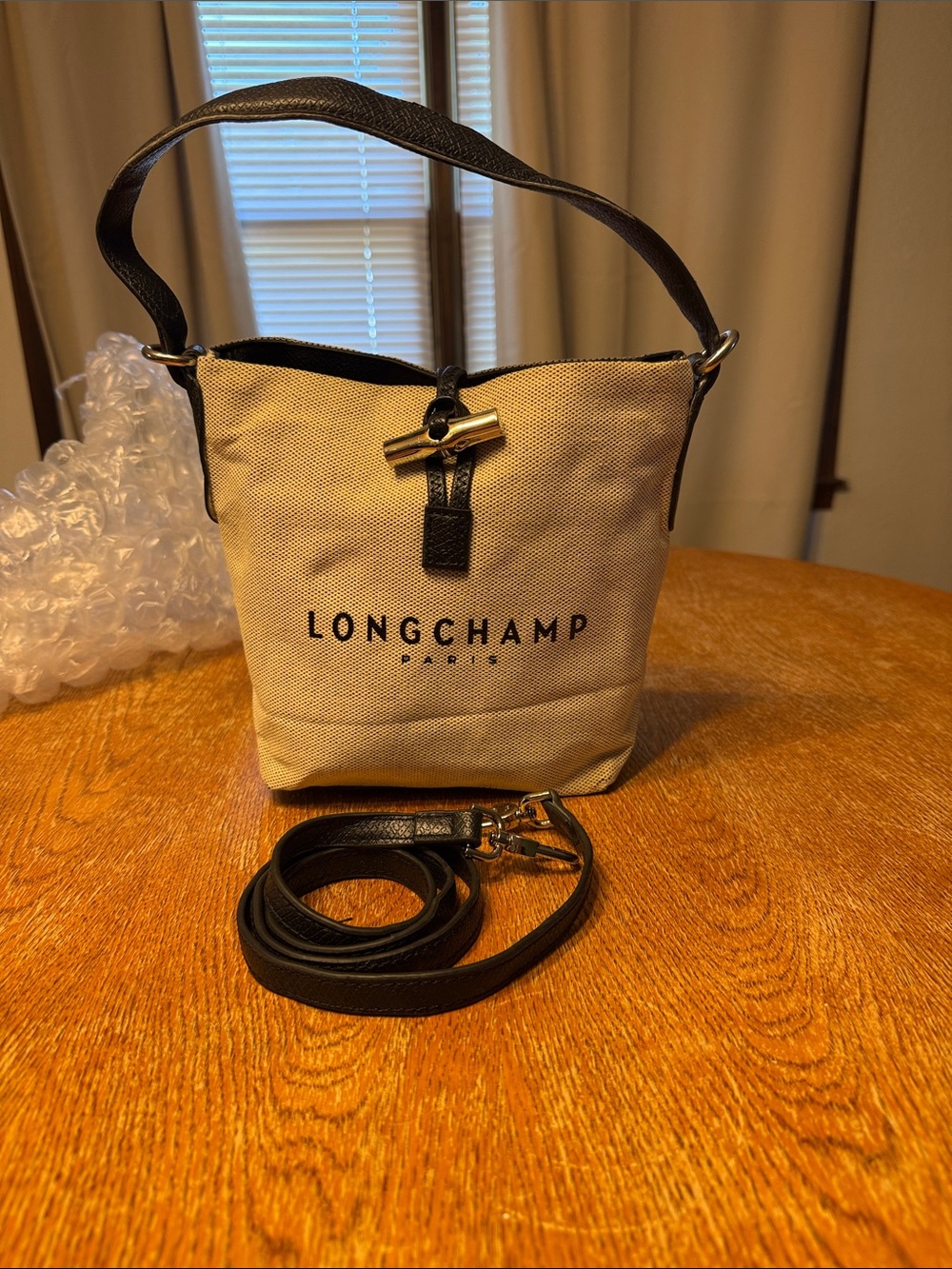 Longchamp Beige Canvas Crossbody Bucket Bag with Black Trim